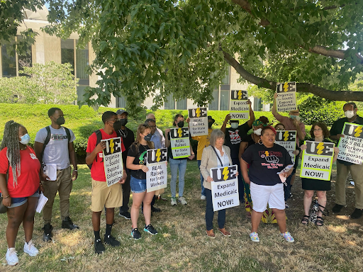 group of people standing outside holding