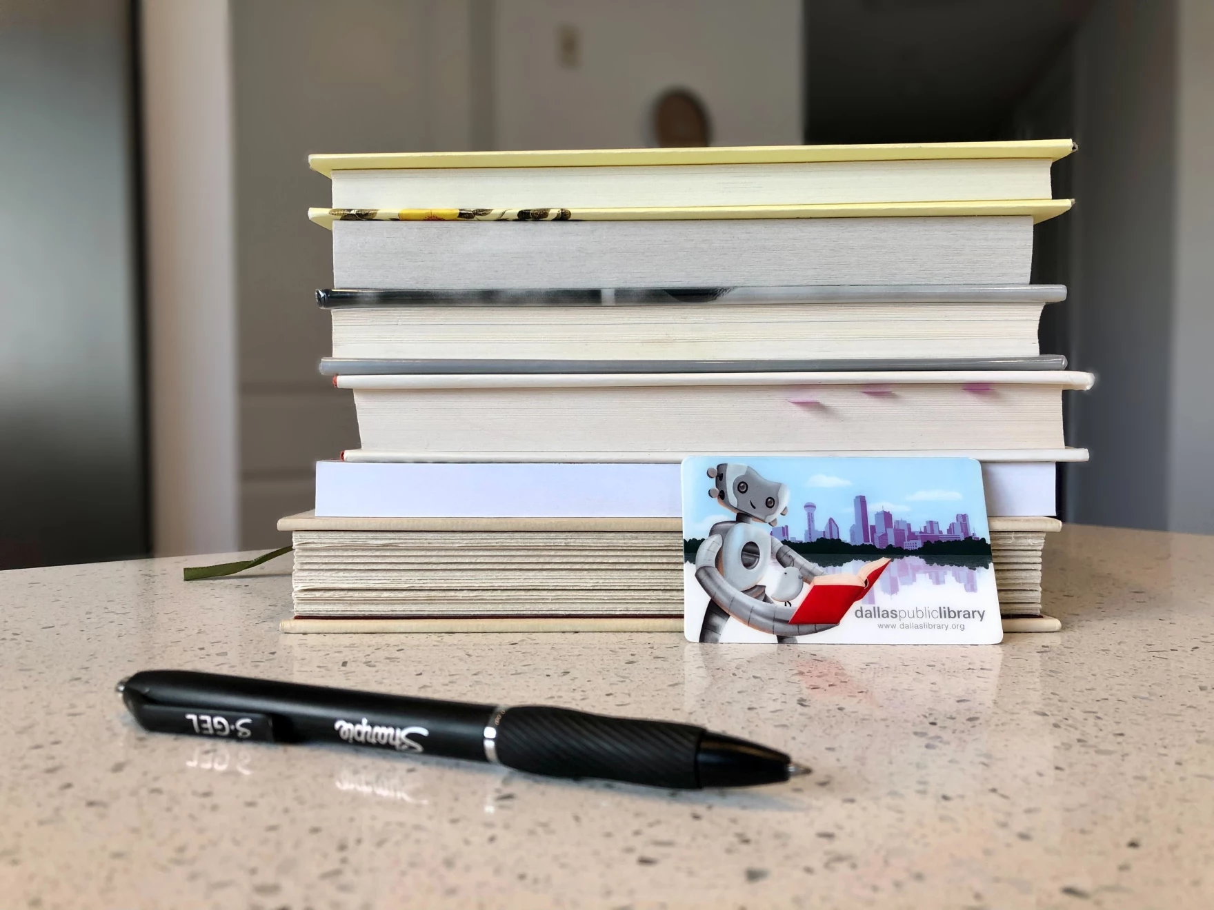Pile of books with an Enhanced Library Card