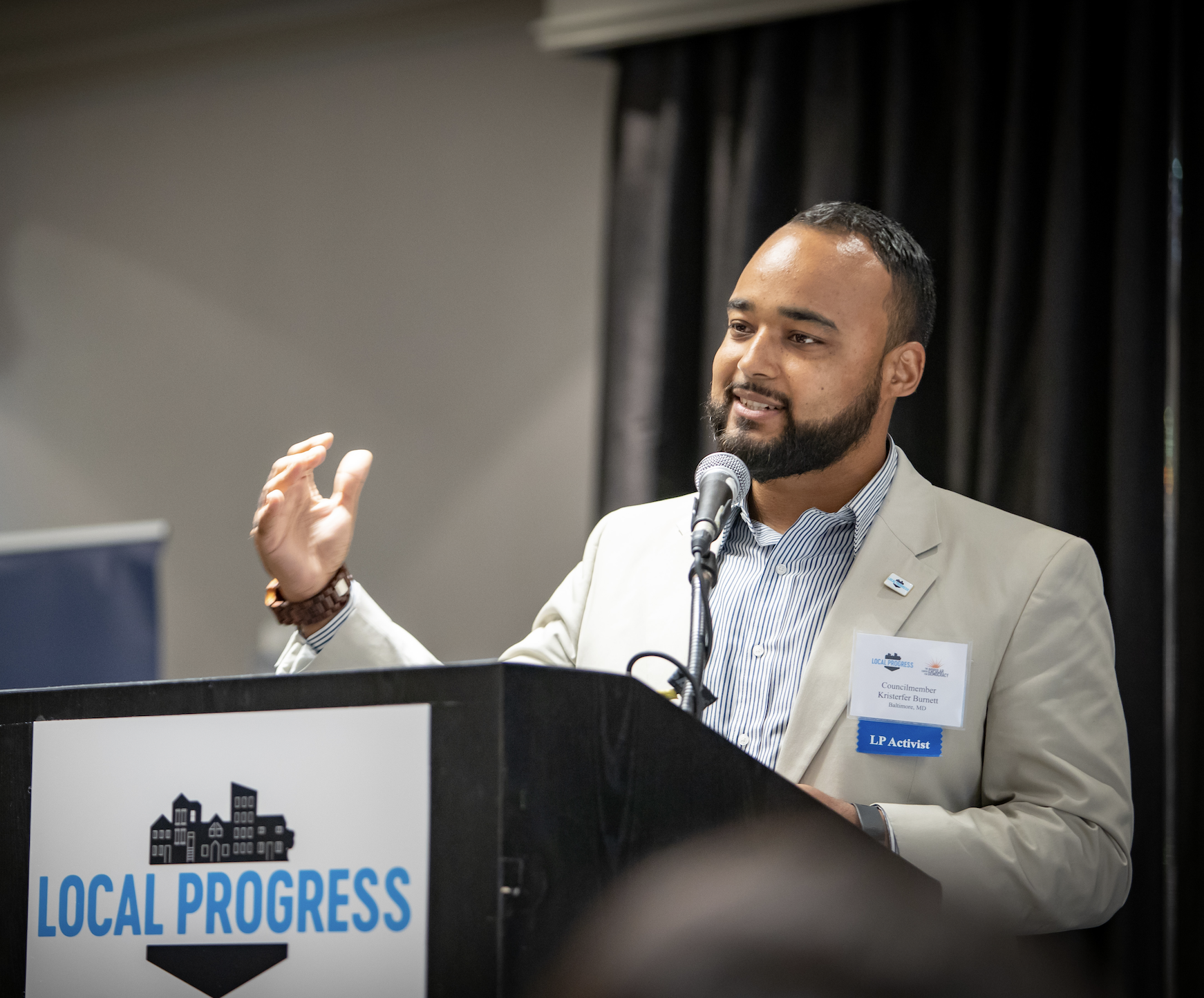 Photograph of Kristerfer Burnett speaking a podium.