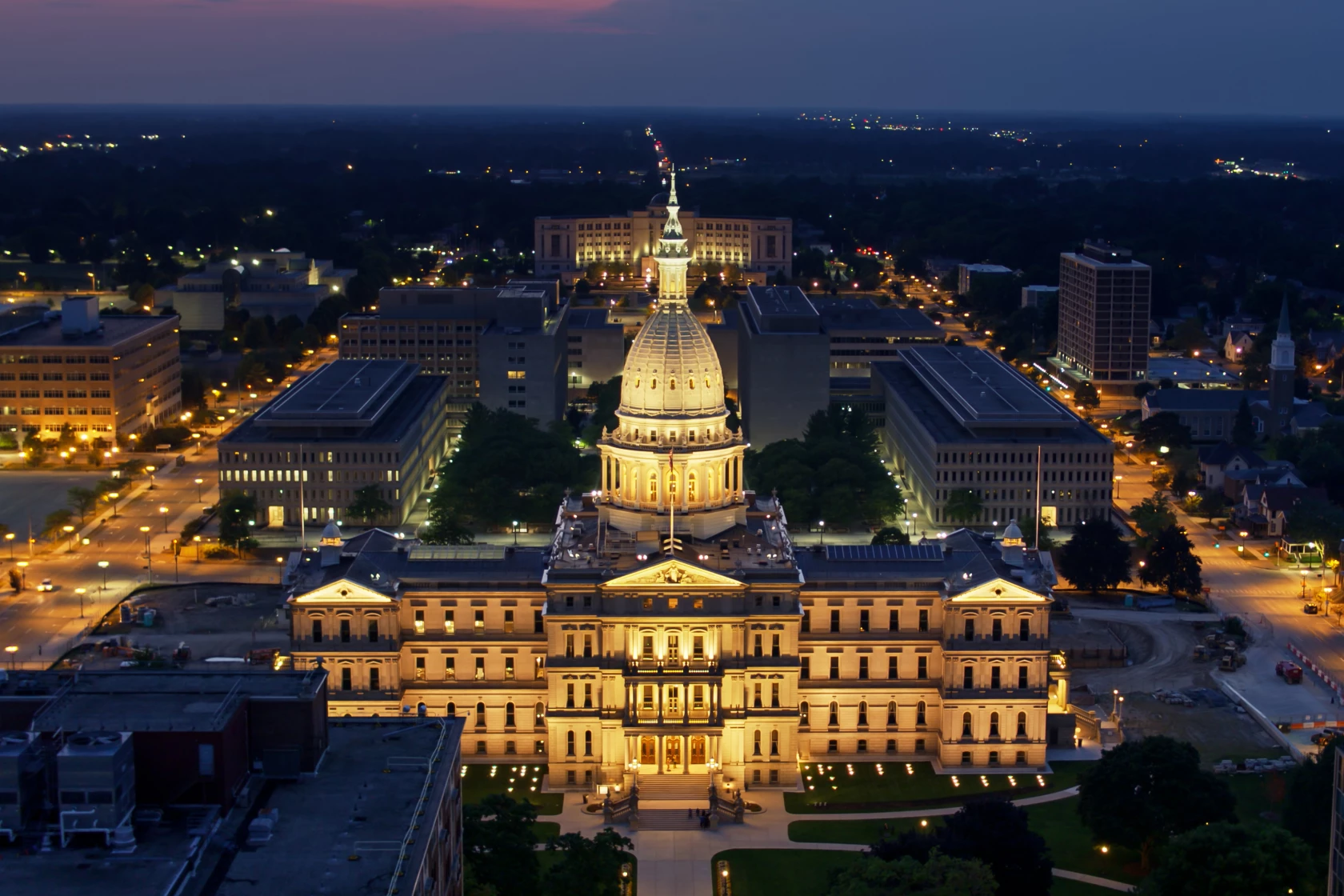 Ariel view of The Michigan State Capitol lit up at night.