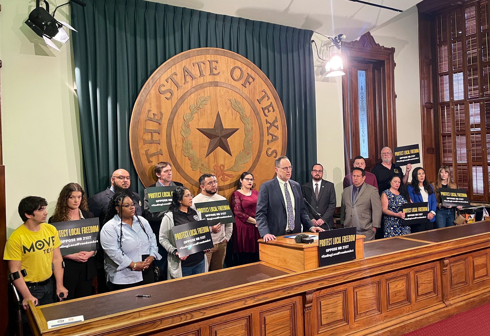 Community groups, local electeds, faith leaders, and labor partners standing in solidarity against HB 2127 with signs.