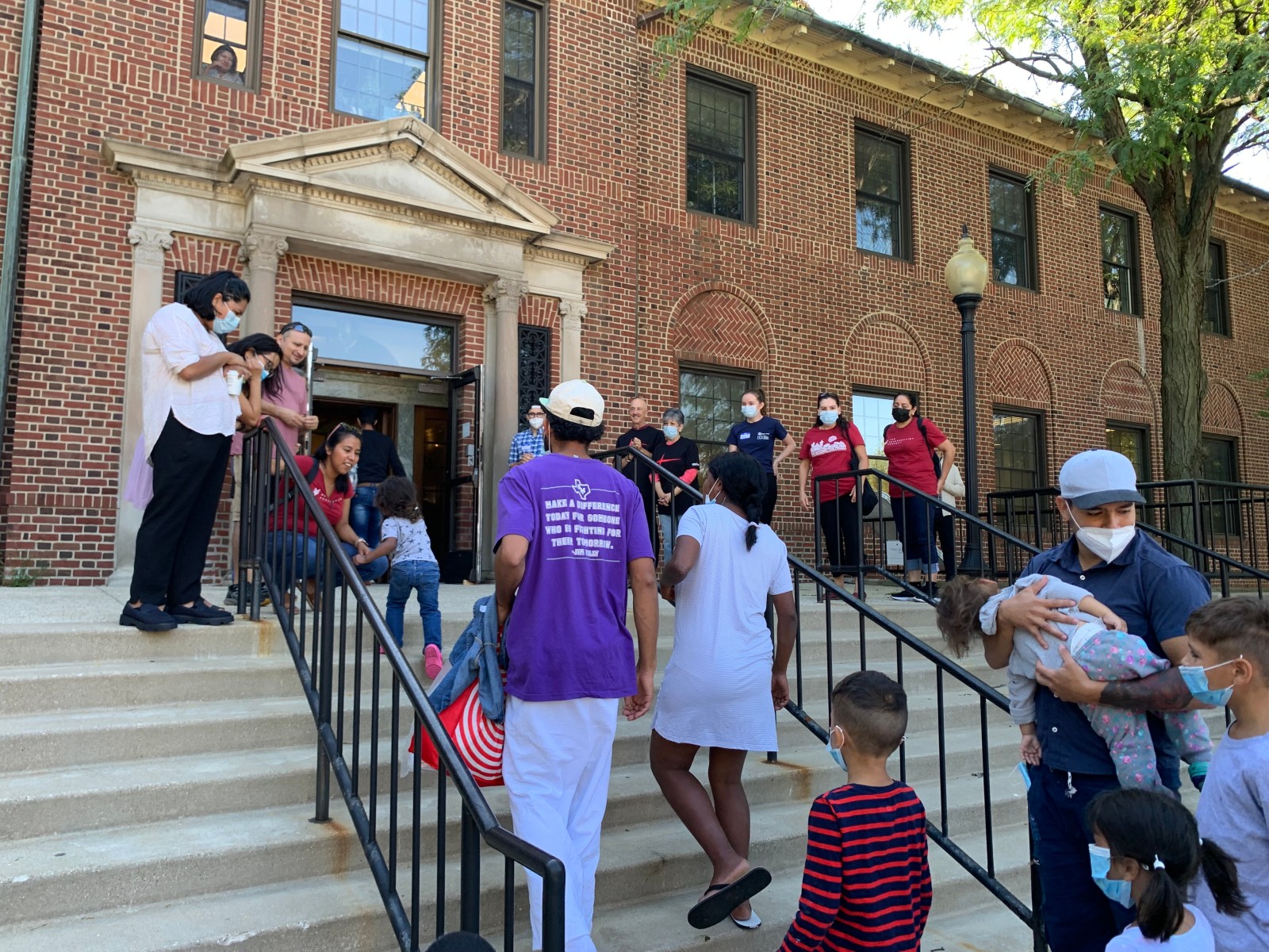 Volunteers from The Resurrection Project in Chicago welcome migrants to shelter