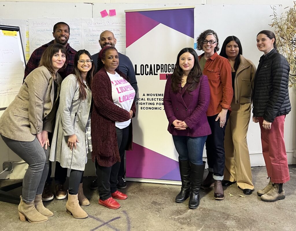 Group photo at the LPMN Organizing Committee Retreat in February -- OC members standing beside a LPMN banner.