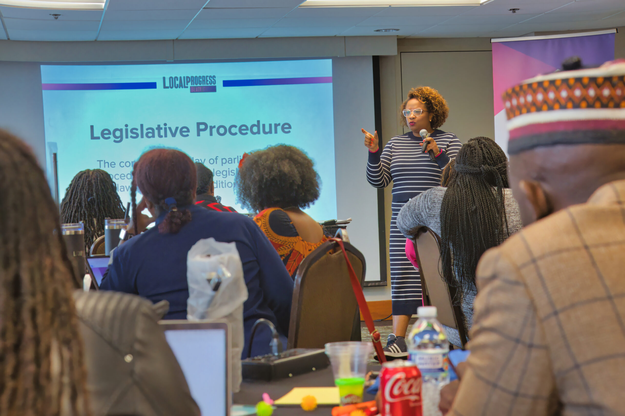 A group of people listening to a presentation