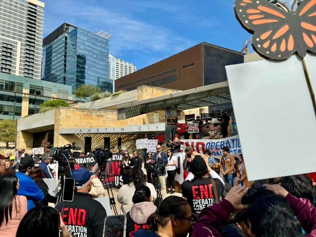 Photograph of a rally in opposition to TX SB4; El Paso County Commissioner David Stout is speaking to a crowd of people holding up signs.